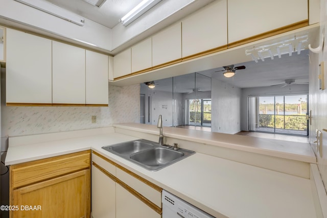 464 Bouchelle Dr Unit 104, New Smyrna Beach, FL 32169 - kitchen with a ceiling fan, a sink, wallpapered walls, and light countertops