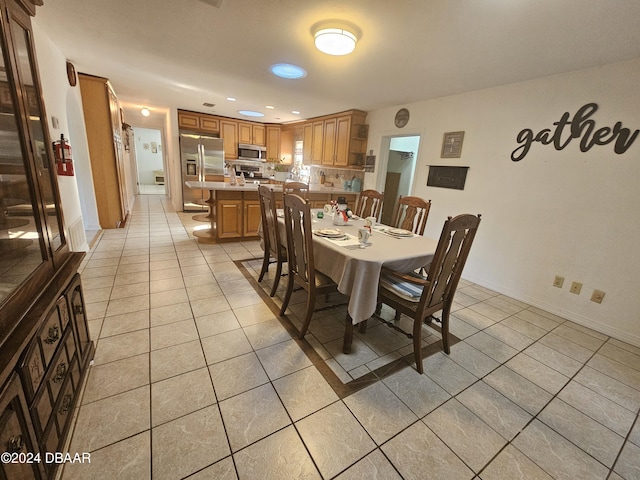 dining space with light tile patterned floors, recessed lighting, and baseboards