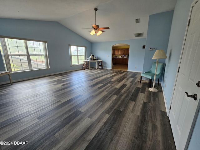 unfurnished living room featuring arched walkways, visible vents, dark wood finished floors, and lofted ceiling