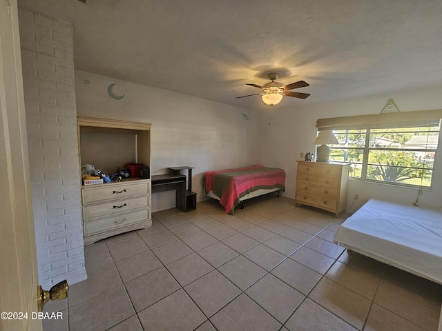 bedroom featuring light tile patterned floors and ceiling fan