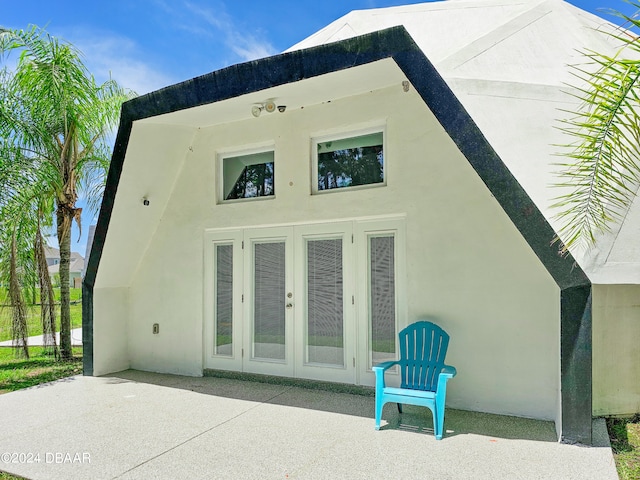 rear view of house featuring a patio and french doors