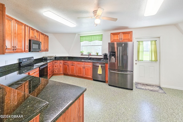 kitchen featuring sink, appliances with stainless steel finishes, a textured ceiling, and ceiling fan