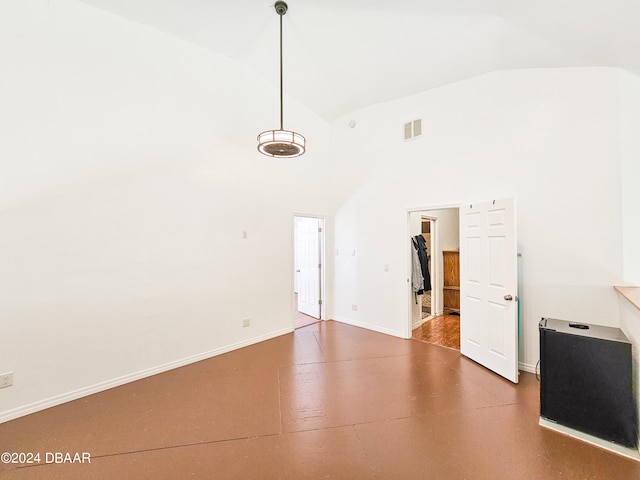 unfurnished living room featuring high vaulted ceiling