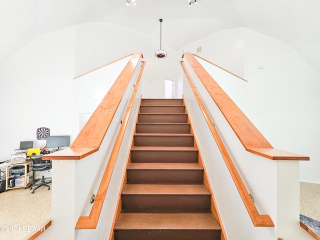 stairs with vaulted ceiling