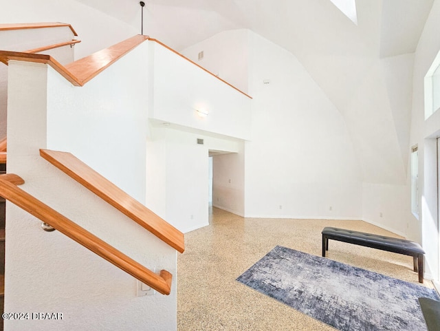 interior space featuring a towering ceiling