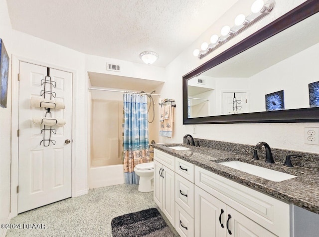 full bathroom featuring toilet, shower / tub combo, vanity, and a textured ceiling