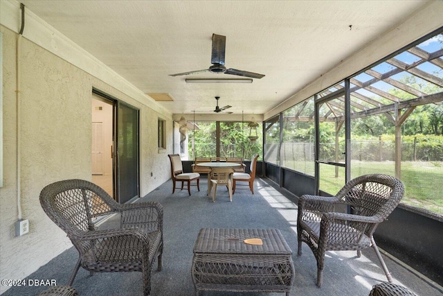 sunroom featuring ceiling fan