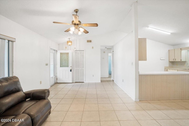 tiled living room with vaulted ceiling and ceiling fan