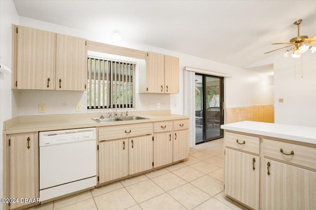 kitchen featuring light brown cabinetry, lofted ceiling, sink, light tile patterned floors, and white dishwasher