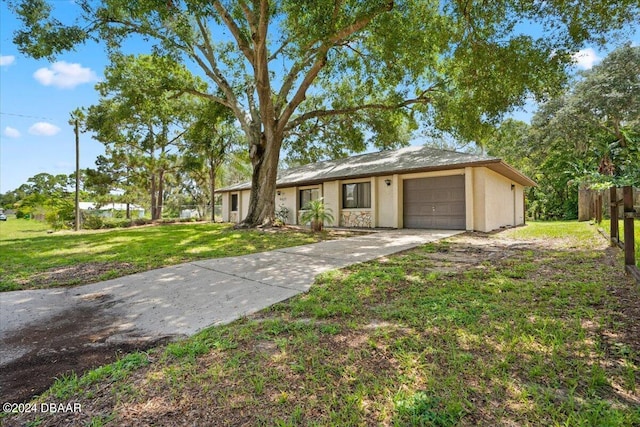 ranch-style house with a garage and a front lawn