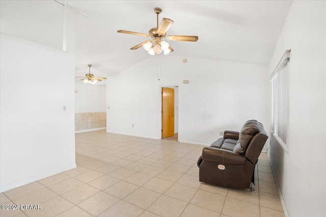 sitting room featuring lofted ceiling, light tile patterned floors, and ceiling fan