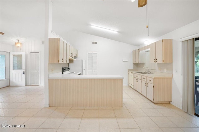 kitchen with lofted ceiling, sink, light brown cabinetry, stainless steel range with electric cooktop, and kitchen peninsula