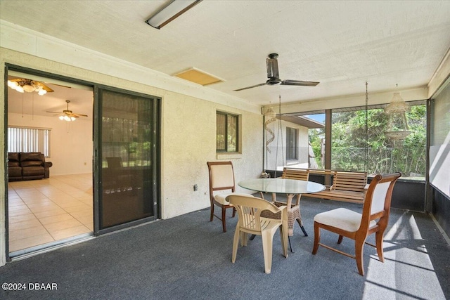 sunroom featuring ceiling fan