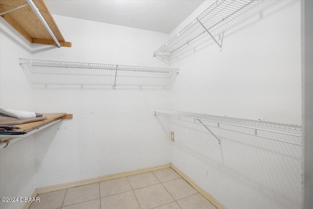 spacious closet featuring tile patterned flooring