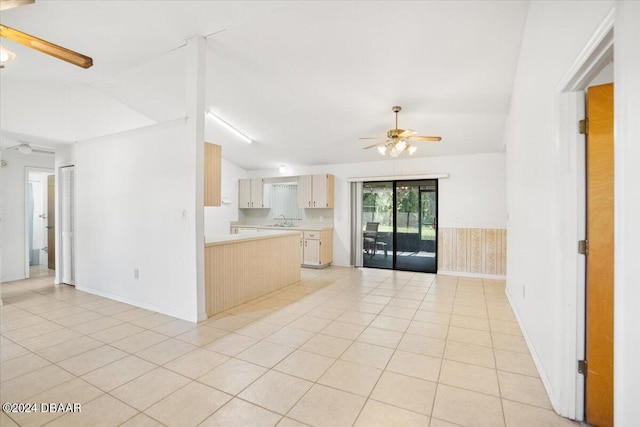 kitchen with ceiling fan, lofted ceiling, light tile patterned floors, and light brown cabinets