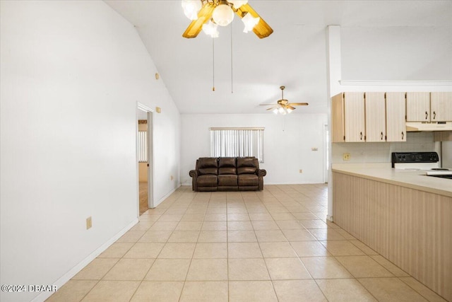 kitchen featuring lofted ceiling, light tile patterned floors, range with electric cooktop, tasteful backsplash, and light brown cabinetry