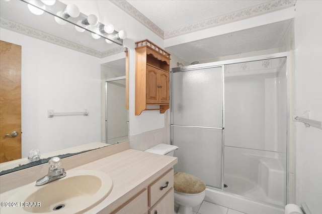 bathroom with toilet, vanity, a textured ceiling, and a shower with shower door