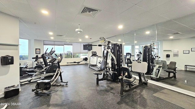 exercise room with a paneled ceiling