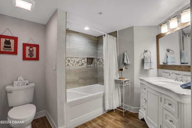 full bathroom with shower / bath combo, hardwood / wood-style floors, vanity, and toilet