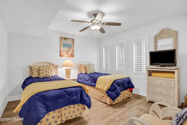 bedroom with hardwood / wood-style floors and ceiling fan