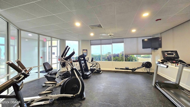 exercise room with a paneled ceiling