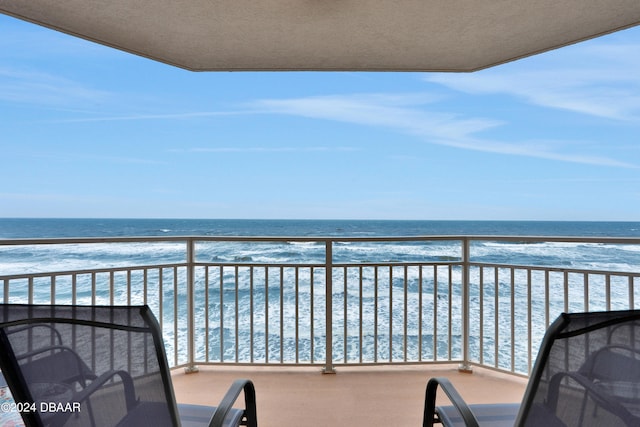 balcony with a view of the beach and a water view