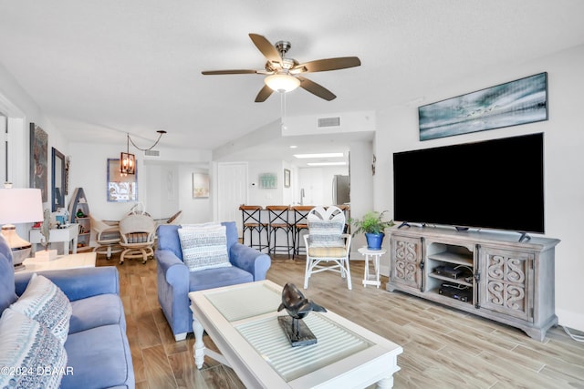 living room with light hardwood / wood-style floors and ceiling fan