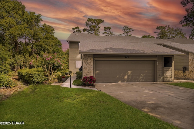 136 Deer Lake Cir, Ormond Beach, FL 32174 - view of front of home featuring stone siding, concrete driveway, a front lawn, an attached garage, and a shingled roof