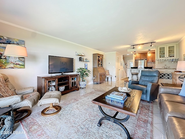 living room with ornamental molding and light tile patterned floors