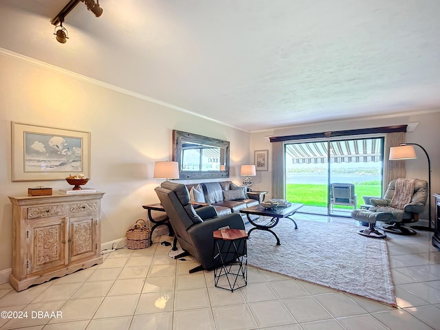 living room featuring rail lighting, tile patterned flooring, baseboards, and crown molding