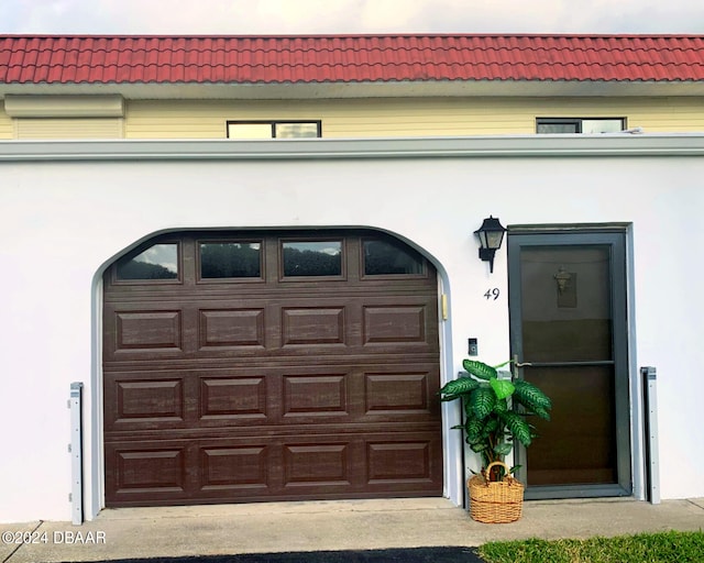 garage featuring concrete driveway