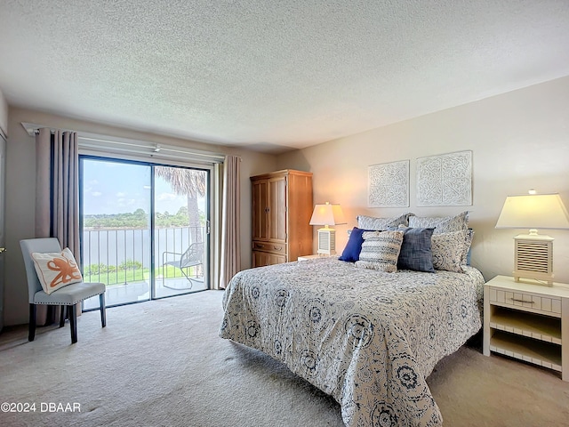 carpeted bedroom featuring access to exterior and a textured ceiling