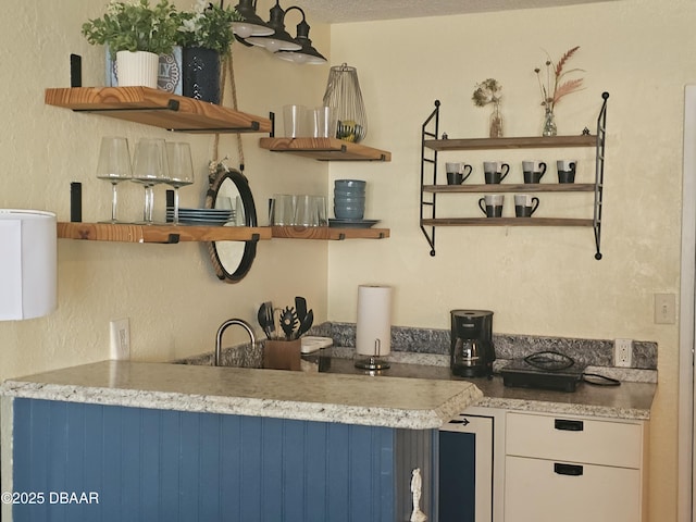kitchen featuring open shelves and white cabinets