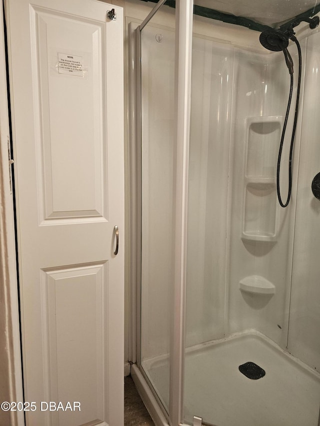 bathroom featuring a shower with door