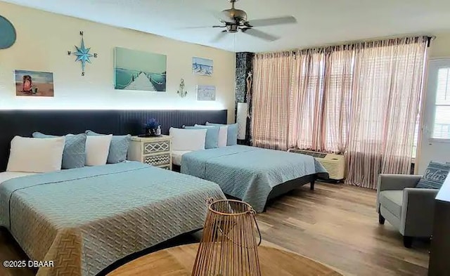 bedroom with wood-type flooring and ceiling fan