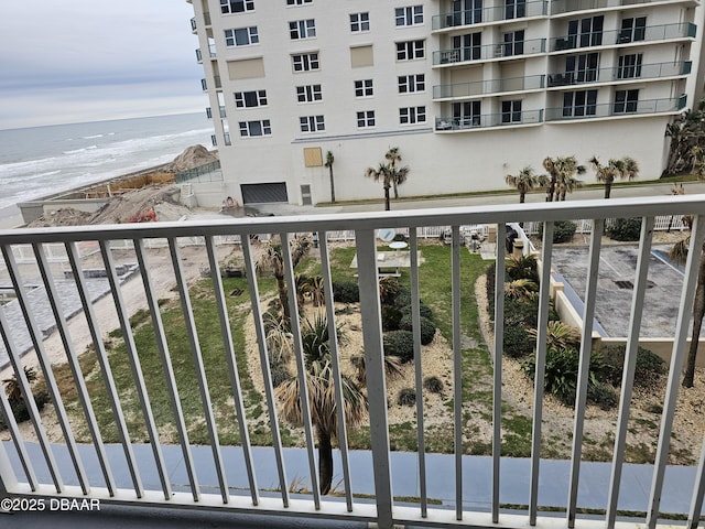 balcony with a water view and a beach view