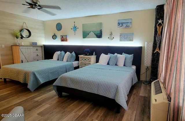 bedroom featuring a textured ceiling, hardwood / wood-style flooring, and ceiling fan