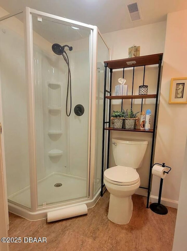 bathroom featuring toilet and walk in shower