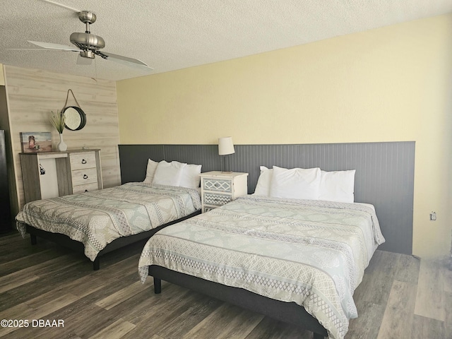 bedroom with a textured ceiling and wood finished floors