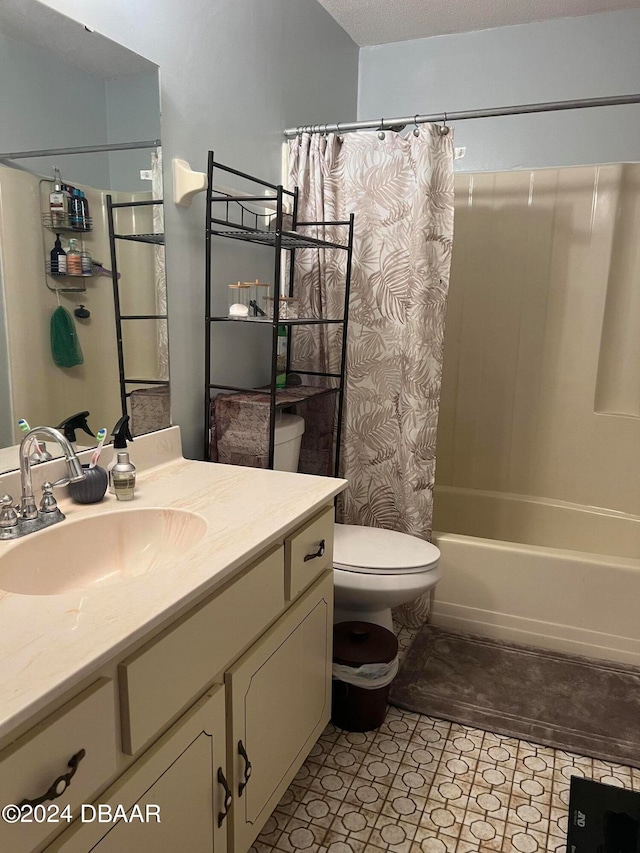 full bathroom with vanity, a textured ceiling, toilet, and shower / tub combo with curtain