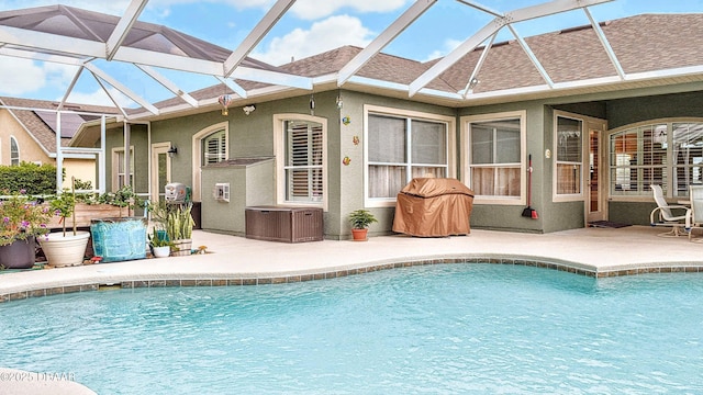 outdoor pool with a patio, central AC unit, and a lanai