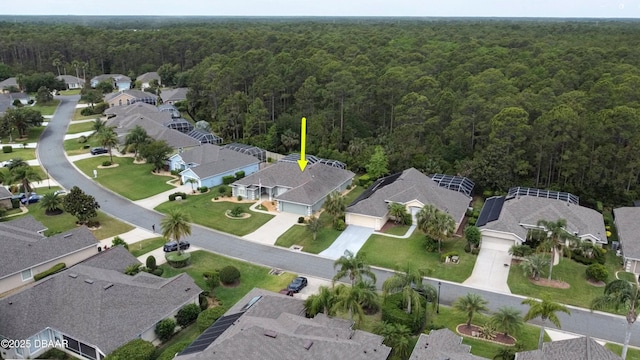 aerial overview of property's location with a forest and nearby suburban area