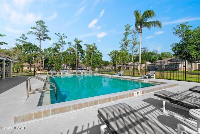 community pool featuring fence and a patio