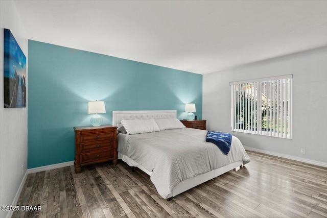bedroom featuring wood finished floors and baseboards