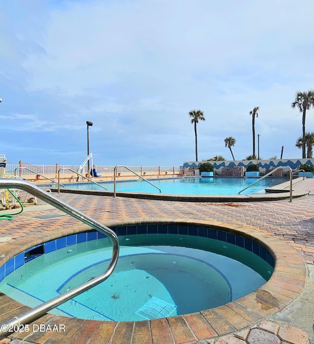 view of swimming pool with a community hot tub