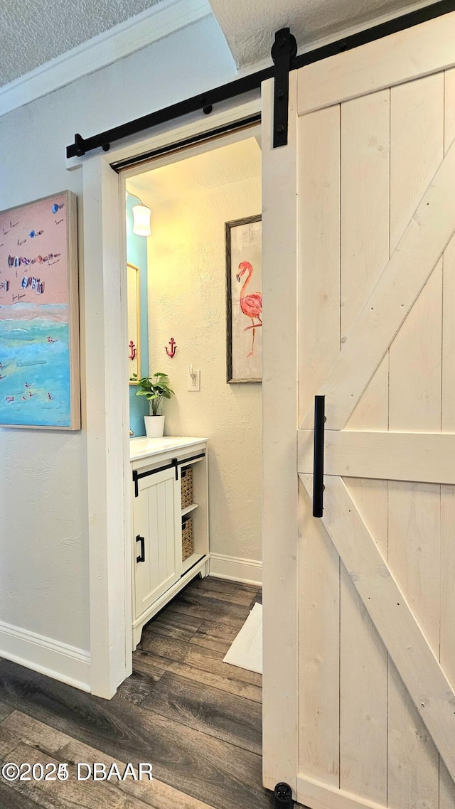 interior space with crown molding, a textured ceiling, and hardwood / wood-style flooring