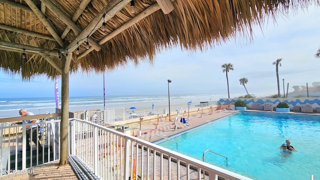 view of swimming pool featuring a water view