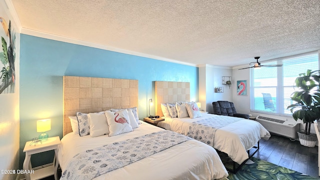 bedroom with wood-type flooring, a textured ceiling, and ornamental molding