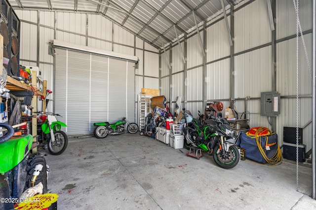 garage featuring electric panel and metal wall
