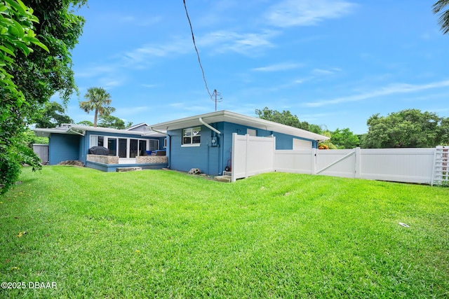 49 Bosarvey Cir, Ormond Beach, FL 32176 - rear view of property with a sunroom and a gate